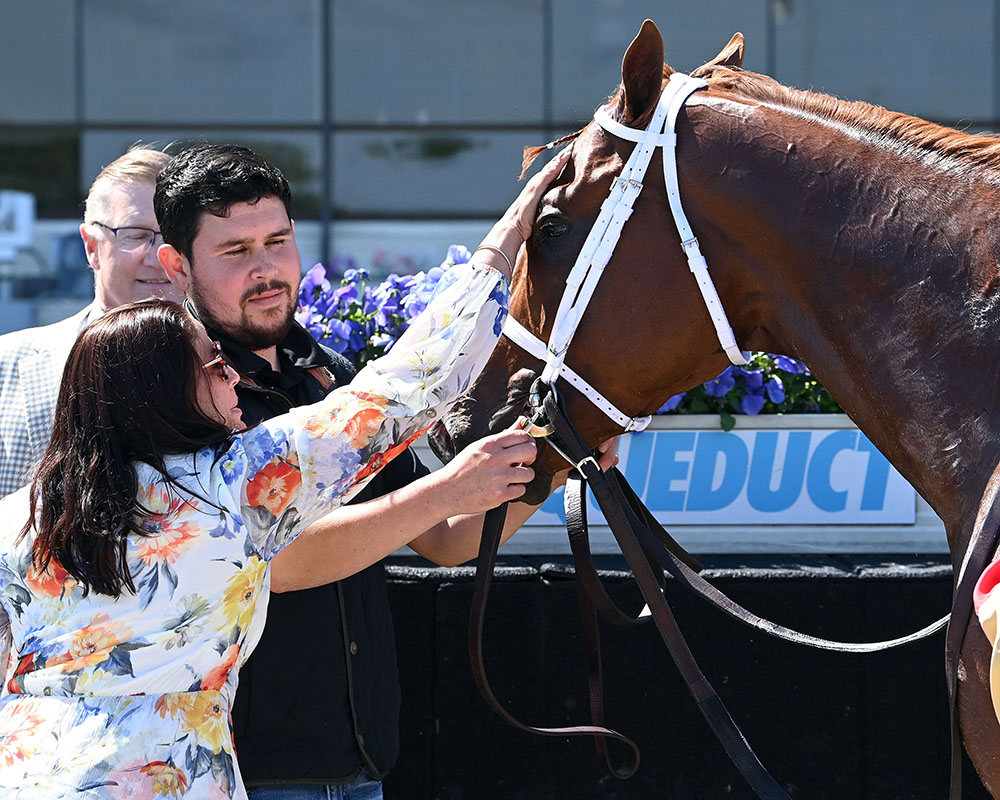 Antiquarian gets a pat from Middleburg team member Aoife after winning the G3 Peter Pan.