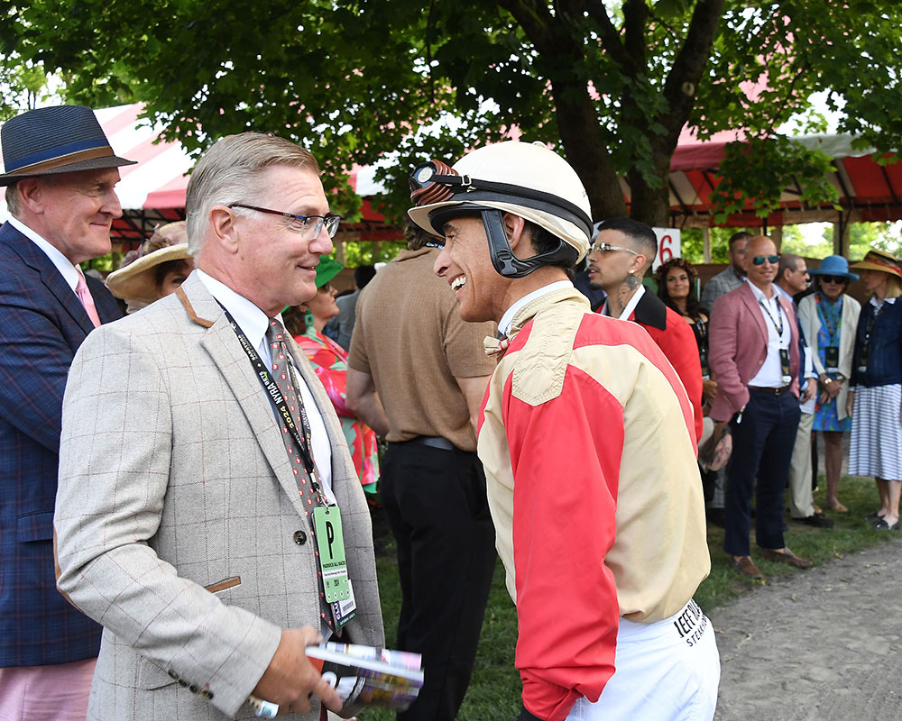 Members of the Centennial Farms Thoroughbred racing partnership that owns Belmont Stakes runner Antiquarian on Belmont Stakes Day at Saratoga Race Course with John Velazquez.